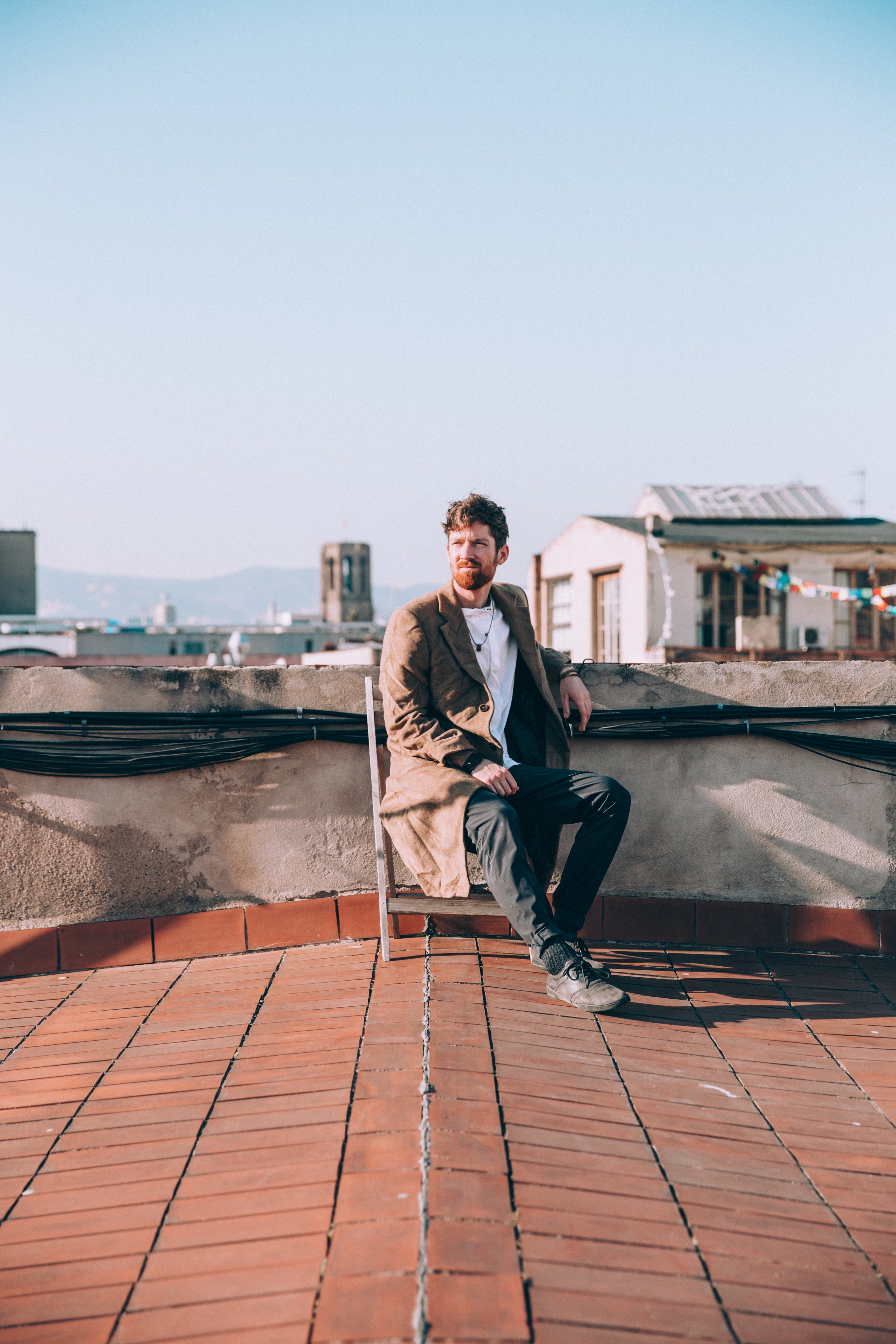 files/man-sits-on-chair-on-roof.jpg